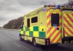 Ambulance driving down road to emergency