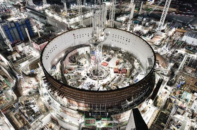 The first reactor unit and the blue steel columns of the turbine building