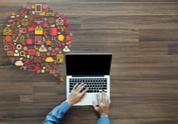 Laptop with speech bubble filled with social media icons
