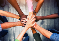 Young people putting their hands together