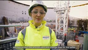 Harriet Ferris, reactor unit trainee, stands inside one of the reactor units dressed in yellow high viz
