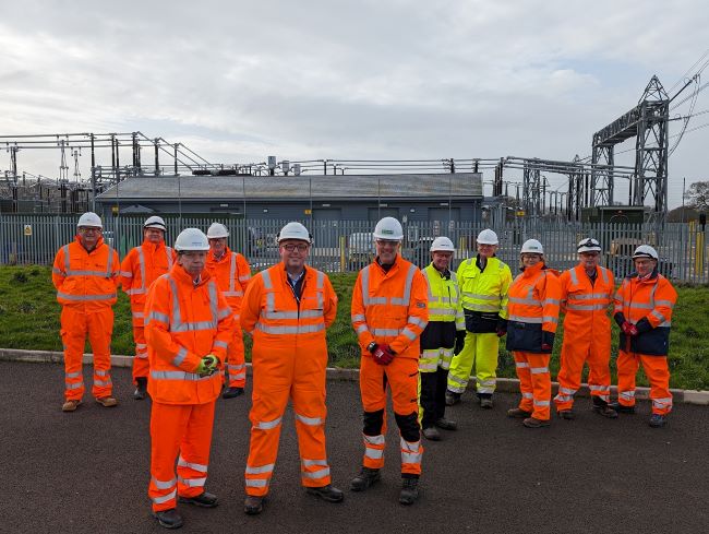 The project team in front of an industrial construction site.