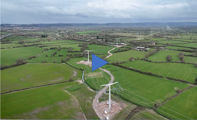 Drone footage of T-pylons complete with conductors in the rural Somerset landscape