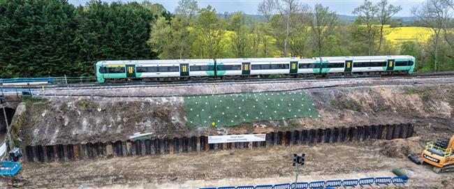 A photo of a Southern Class 377 train going over a repaired embankment near Edenbridge