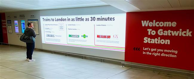 A photo of the new customer information wall at Gatwick Airport with train information.